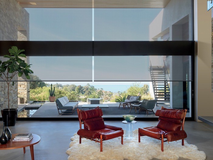 A living room with vintage leather chairs and a plush sheepskin rug.